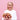 Woman holding a colorful bouquet against a pink background