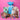 Assorted Easter treats including a blue gift box, chocolate, candies, and a bunny plush toy on a pink background.