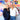 Two women standing in front of a colorful abstract wall art.