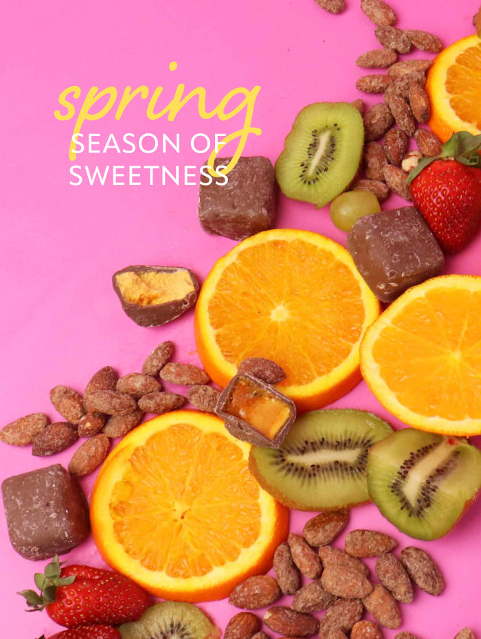 Assorted fruits and candies on a pink background with 'spring season of sweetness' text.
