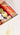 Gift box with fruits, chocolates, and a bottle of wine on a white background with 'gift deliciously' text.