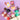Assorted confectionery items including cheeses, chocolates, and a picnic blanket on a purple background