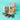 Bowl of cookies with chocolate bars and a box on a teal background