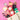 Assorted snacks, chocolates, and a bottle of champagne on a pink background